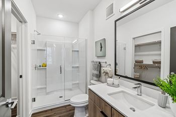Modern bathroom with glass shower and dual vanity